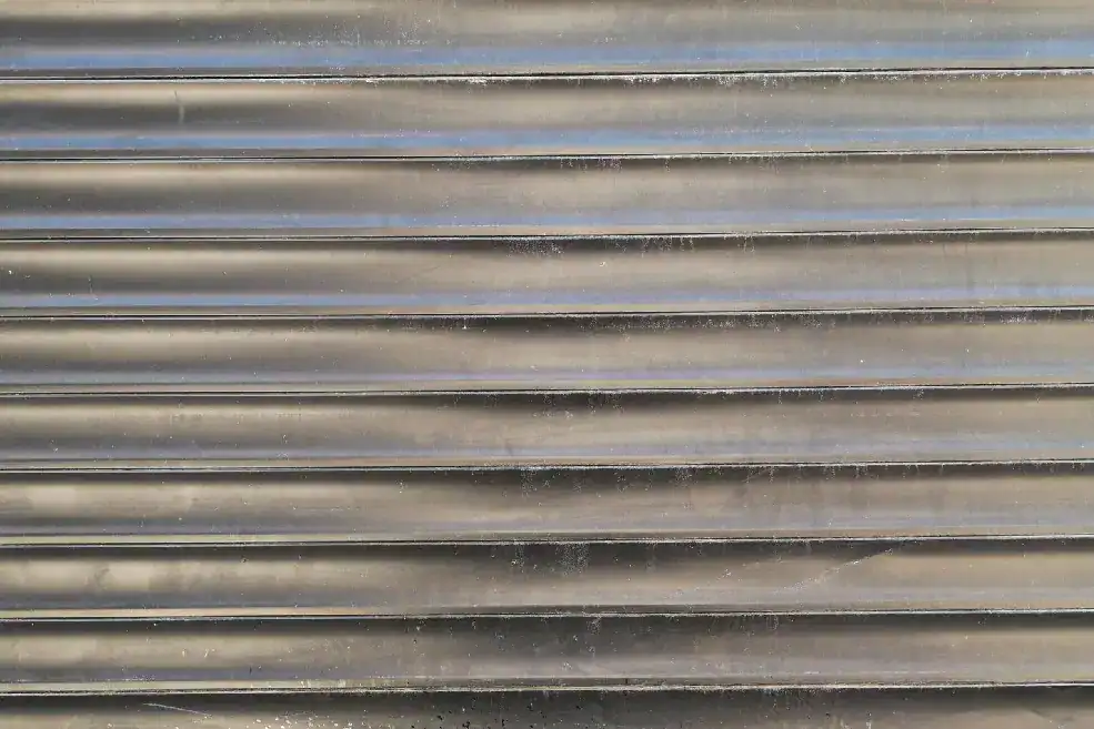 Close-up of a gray metal garage door with horizontal panels