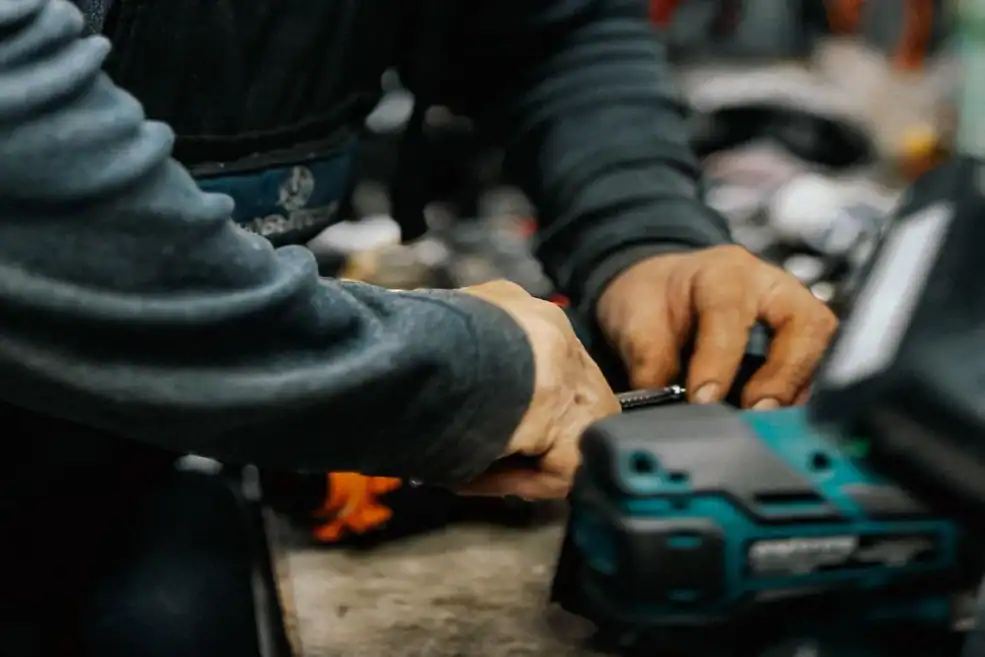 Technician working with tools inside a garage