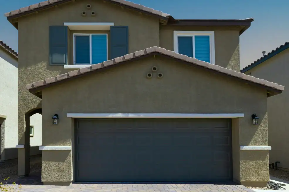 brown house with blue raised panel garage door
