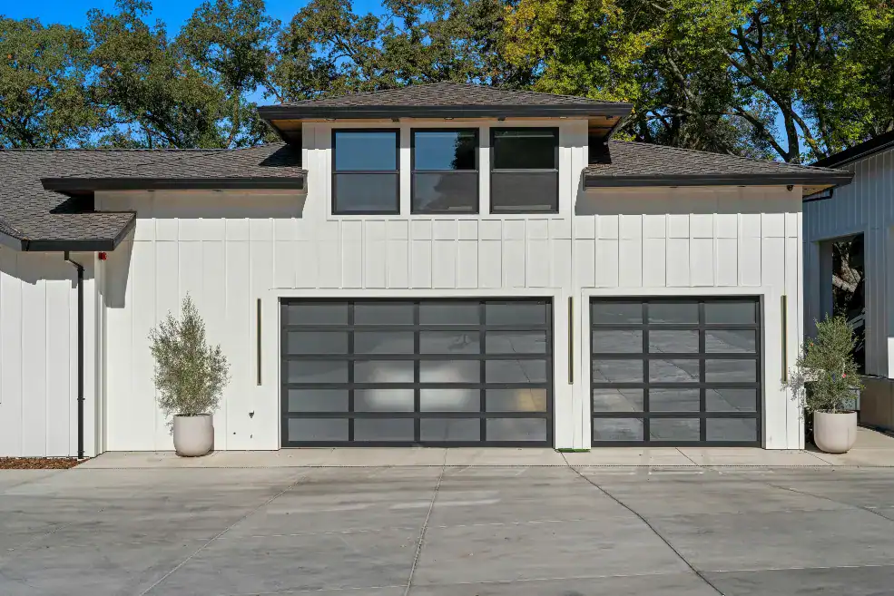 modern white house with glass garage doors