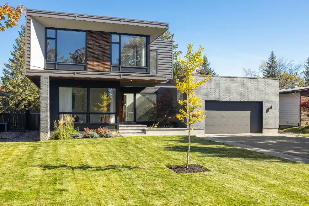 multi-level modern house with grey garage door